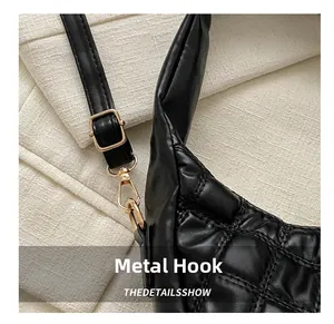 Detailed close-up of premium black quilted leather bag with elegant gold metal hardware