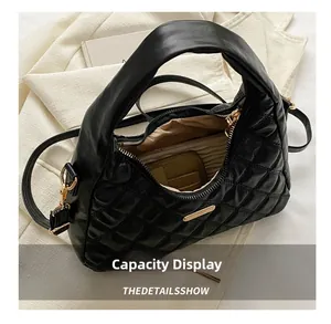 Top view of black quilted crescent bag interior showcasing storage capacity for essentials
