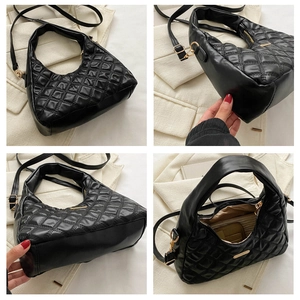 Macro details of black quilted hobo bag featuring gold hardware and internal storage