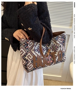 Detail of colorful woven tote bag with HOUTO leather patch and silver chain strap