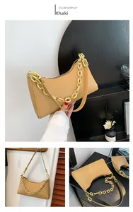 Detailed view of khaki crocodile pattern baguette bag with stylish metal chain strap