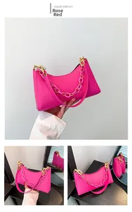 Detailed views of magenta crocodile embossed shoulder bag with pink resin chain link