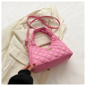 Close-up of pink quilted hobo bag featuring diamond stitching and gold metal hardware