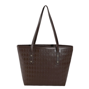 Minimalist coffee brown quilted tote bag with refined shoulder straps and metal rivets