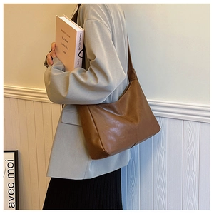 Detailed side view of dark brown PU shoulder bag showing leather texture and stitching