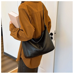 Close-up of the black soft PU leather hobo bag showing its glossy finish and spacious shape
