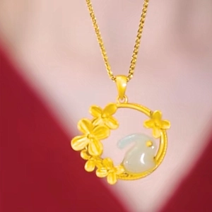 Golden rabbit pendant necklace with floral round frame and jade-like stone inlay