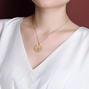 Elegant gold rabbit necklace with jade pendant on woman in white dress for gift