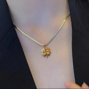 Gold titanium steel four-leaf clover pendant necklace with textured clover on snake chain