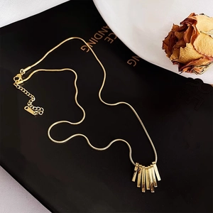 Gold-tone titanium sunburst pendant necklace with a sleek snake chain and lobster clasp