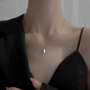 Minimalist silver rectangle pendant necklace with delicate metal beads on titanium chain