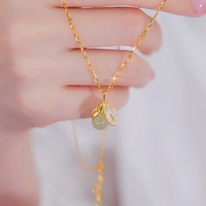 Golden leaf necklace with green jade pendant and shimmering crystals for women