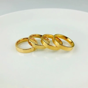 Set of four minimalist 18K gold plated titanium steel rings with polished and matte finishes