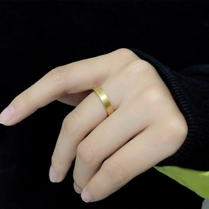 Minimalist 18K gold plated titanium steel ring shown on index finger for women and men