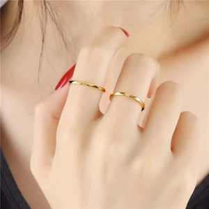 Minimalist gold titanium steel rings with geometric facets and center crystals on model