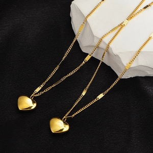 Polished gold heart pendant necklace with Love girl engraving on a minimalist chain