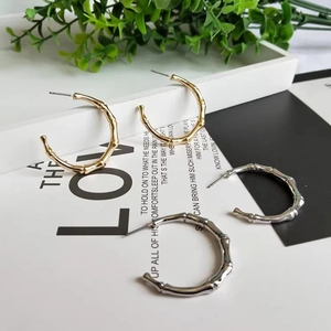 Bamboo textured C-shaped hoop earrings in gold and silver finish for women