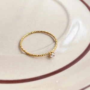 Elegant 18k gold plated ring with thin textured band and sparkling round diamond center