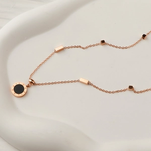 Rose gold stainless steel necklace featuring a double-sided love pendant and geometric beads