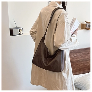 Detail of vintage brown leather hobo bag showing large capacity and smooth texture