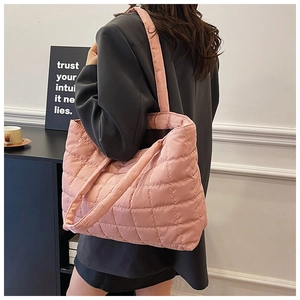 Detail view of pink quilted tote bag showing soft nylon material and diamond stitching