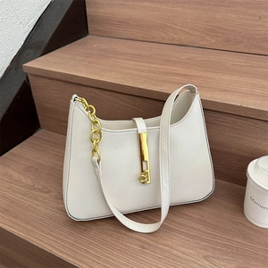 Chic cream PU leather shoulder bag with gold chain strap and metallic lock on wooden steps