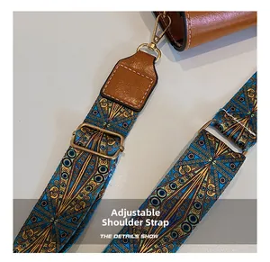 Detail of bohemian adjustable bag strap with blue and gold geometric patterns and leather ends