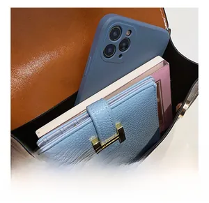 Interior view of vintage monogram crossbody bag showing storage for phone and wallet