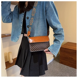 Brown vintage flap bag featuring ethnic embroidery wide strap and geometric patterns