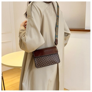 Detail view of vintage patterned crossbody bag with ethnic embroidered wide strap