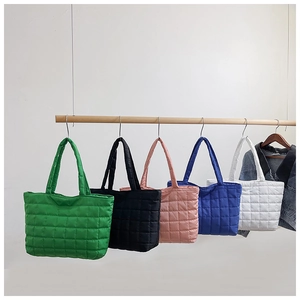 Detailed display of five color options for the quilted puffer tote bag on a hanging rack