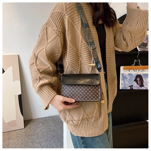 Fashionable black flap crossbody bag with vintage pattern and wide woven shoulder strap