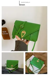 Detail of green leather envelope bag featuring unique triangular metal twist lock closure