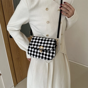 Classic black and white plaid tweed saddle bag with a gold horseshoe clasp for women