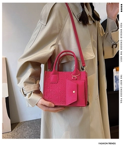 Detail of rose red felt tote bag with geometric embossed pattern and mini coin purse