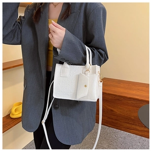 Detail of white mini felt tote bag set with quilted round pattern and matching coin purse