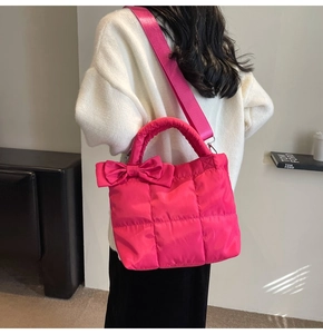 Back view of hot pink quilted puffer tote bag with large bow and wide shoulder strap