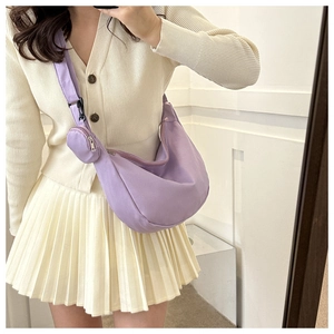 Detail of lavender crescent canvas bag with matching mini pouch and wide shoulder strap