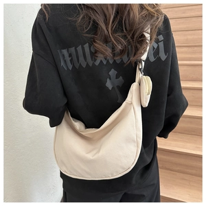 Detail of beige corduroy crescent crossbody bag with small matching round coin purse pouch
