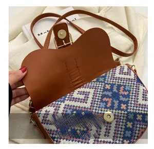 Detail of metal magnetic buckle and geometric ethnic fabric on a saddle bag
