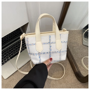Elegant white tweed plaid handbag with cream leather strap and golden hardware accents