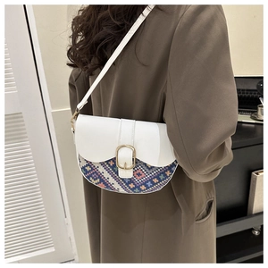 Chic saddle bag featuring colorful geometric woven patterns and a gold oval buckle detail