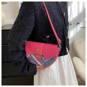 Detail of pink saddle bag with ethnic geometric weaving and gold buckle closure