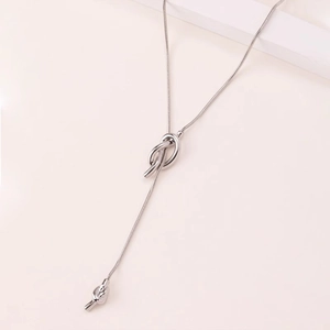 Close-up of minimalist silver adjustable sailor knot Y-necklace on sleek snake chain