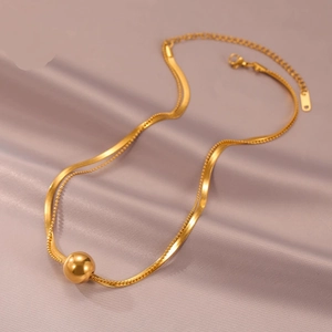 Elegant double-layered gold snake chain and bead necklace with polished metal ball pendant