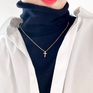 18k gold plated stainless steel cross pendant necklace worn on female model over black top