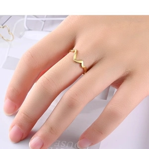 French heartbeat wave ring in gold stainless steel shown on model finger