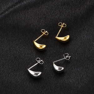 Gold and silver water drop stud earrings set with a sleek polished finish on black silk