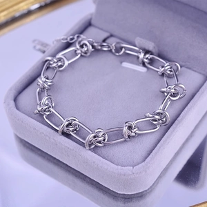 Polished silver thorn chain bracelet with adjustable lobster clasp in a jewelry box