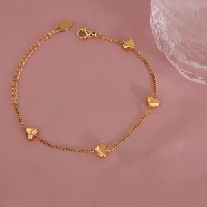 Minimalist gold titanium steel bracelet for women featuring four heart charms and lobster clasp